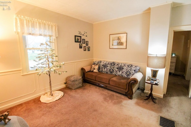 carpeted living room with ornamental molding