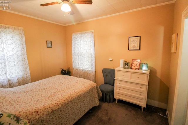 bedroom featuring dark carpet, ceiling fan, and ornamental molding