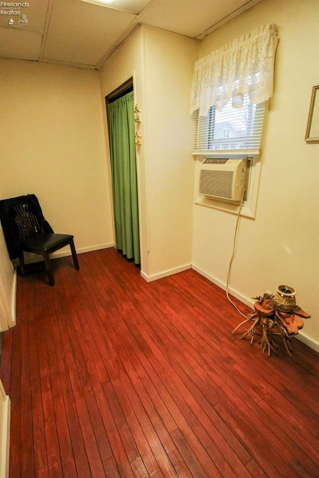 sitting room featuring a paneled ceiling, hardwood / wood-style floors, and cooling unit