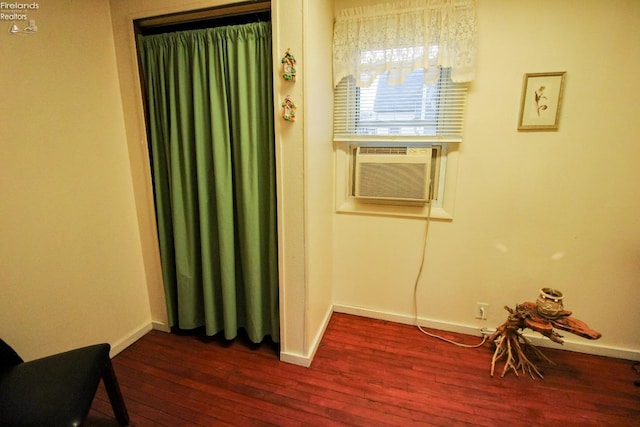 interior space featuring cooling unit and dark hardwood / wood-style floors