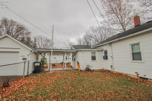 back of property featuring a garage