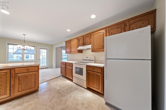 kitchen with decorative light fixtures, a chandelier, and white appliances