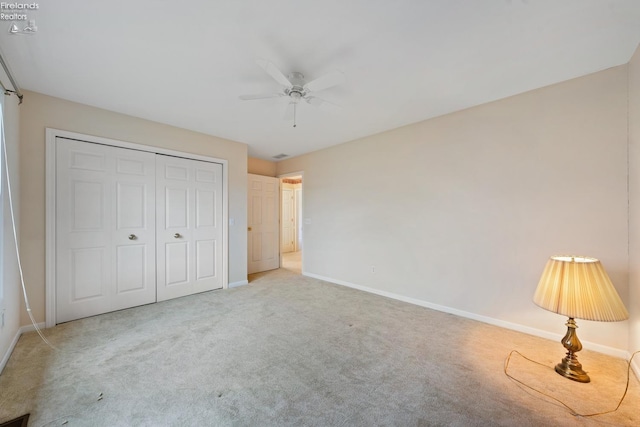 unfurnished bedroom featuring carpet, a closet, and ceiling fan