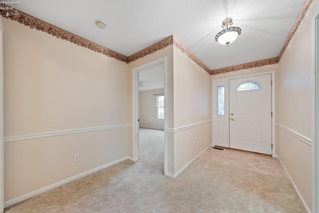 entryway featuring a healthy amount of sunlight and light carpet