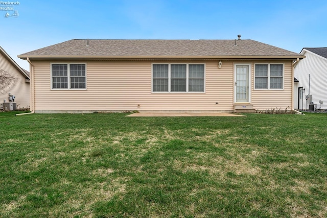 rear view of house featuring a patio area, a yard, and central AC unit