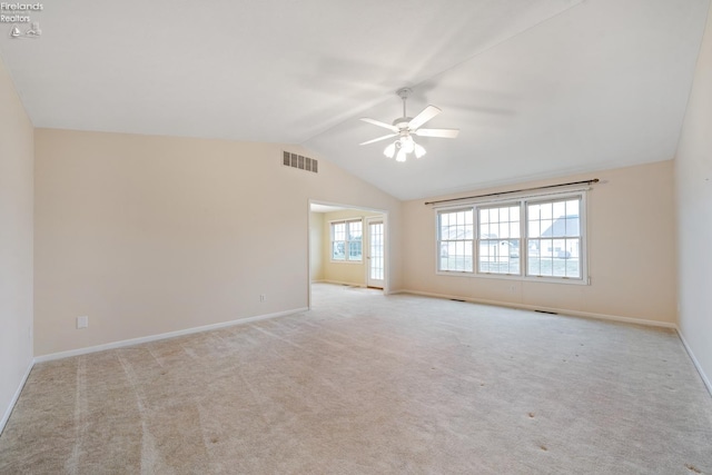 spare room with light carpet, ceiling fan, and lofted ceiling