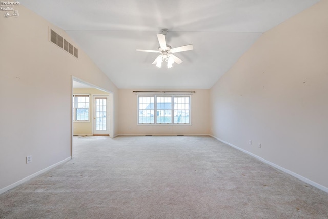 unfurnished room featuring ceiling fan, light colored carpet, and vaulted ceiling