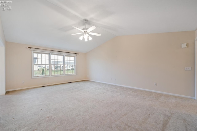 carpeted empty room with vaulted ceiling and ceiling fan