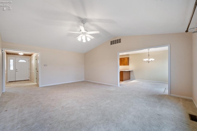 unfurnished living room with light carpet, ceiling fan with notable chandelier, and lofted ceiling