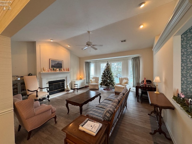 living room with ceiling fan, dark hardwood / wood-style flooring, and vaulted ceiling