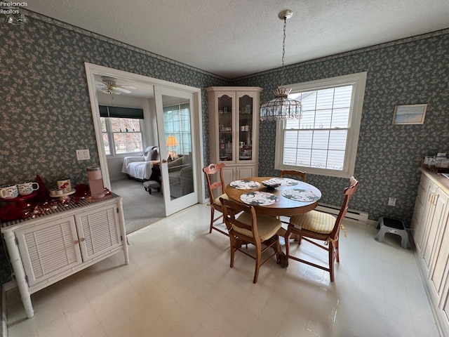 dining area with french doors, a textured ceiling, and ceiling fan