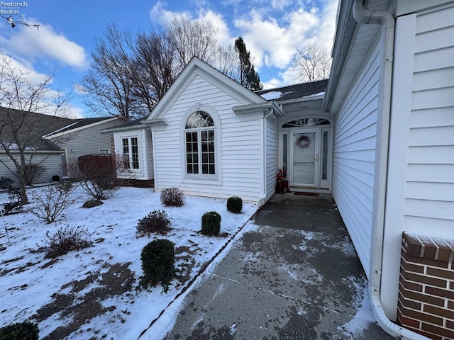 view of snow covered property entrance