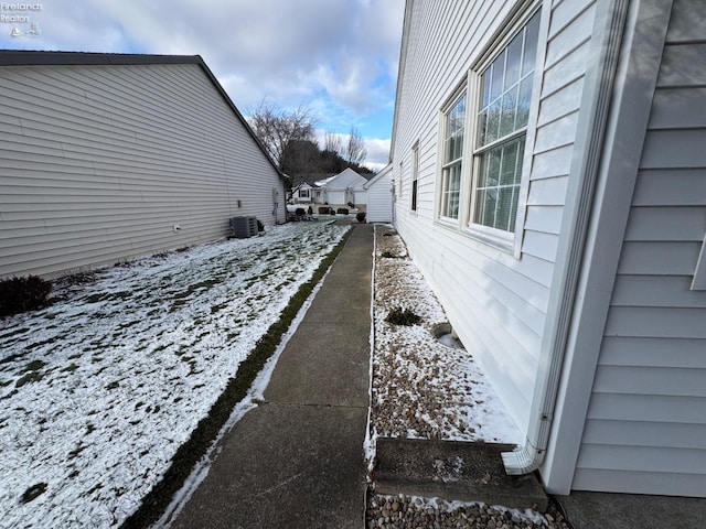 yard layered in snow with central AC