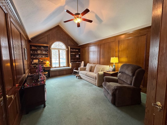 carpeted living room featuring a textured ceiling, ceiling fan, built in features, lofted ceiling, and wood walls