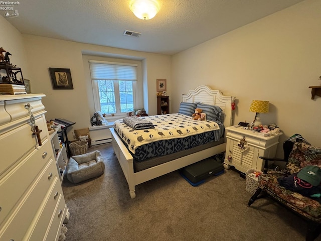 bedroom featuring dark colored carpet, baseboard heating, and a textured ceiling