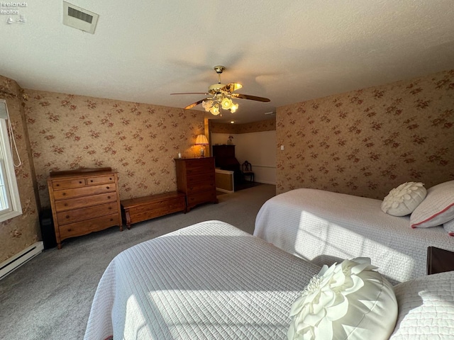 bedroom featuring ceiling fan, carpet floors, a textured ceiling, and a baseboard heating unit