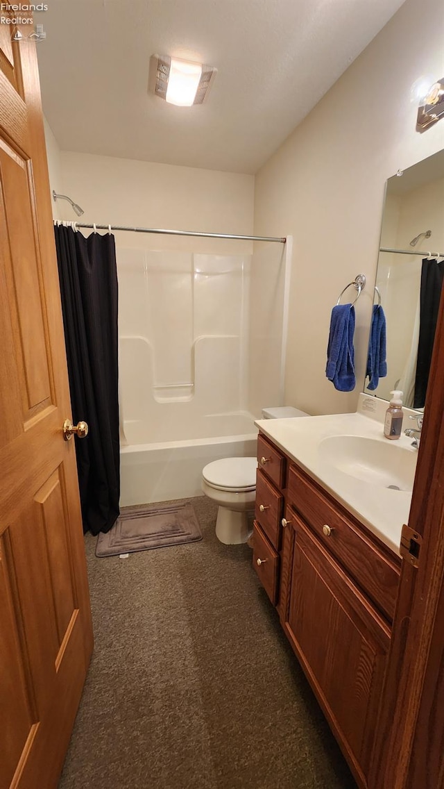 full bathroom featuring shower / bath combo, vanity, and toilet