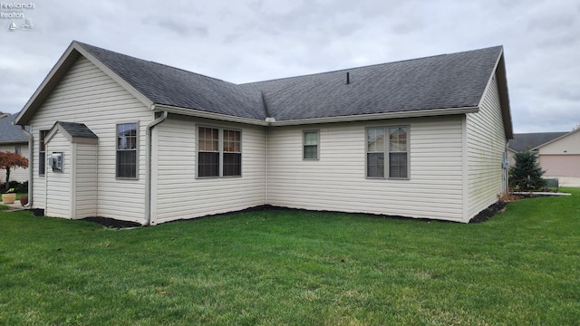 back of house with a lawn