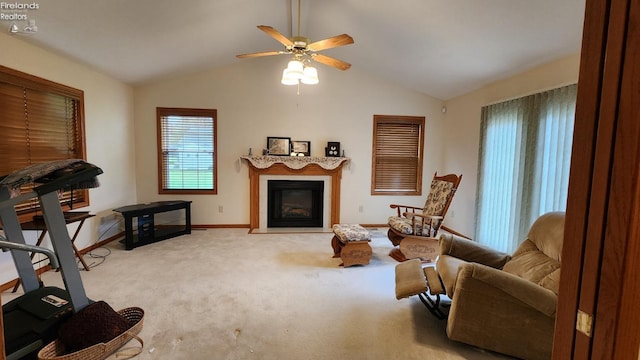 living area featuring light colored carpet, vaulted ceiling, and ceiling fan