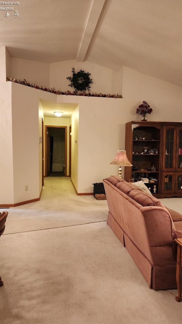 living room with light colored carpet and lofted ceiling with beams