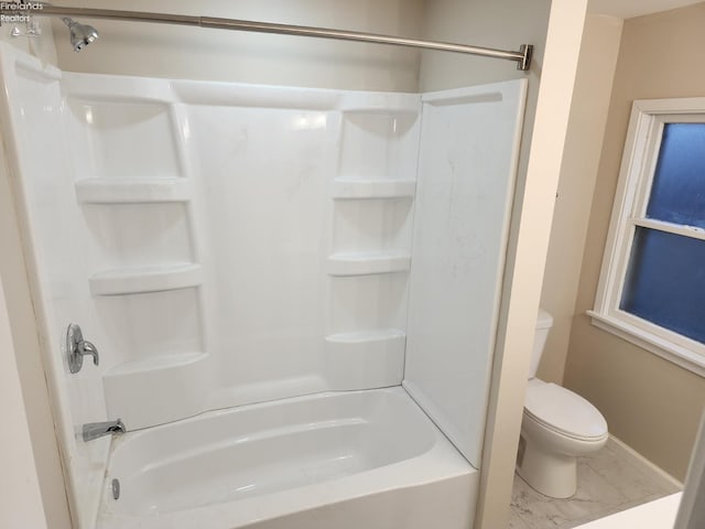 bathroom featuring shower / tub combination and toilet