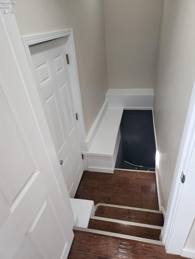 stairway featuring wood-type flooring