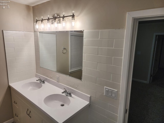 bathroom with vanity and tile walls