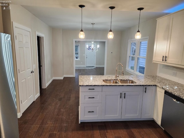 kitchen featuring light stone counters, stainless steel appliances, dark wood-type flooring, sink, and white cabinetry