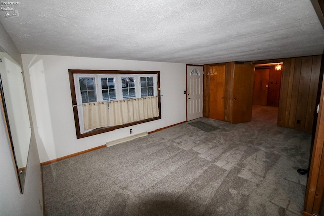 spare room with carpet floors and a textured ceiling