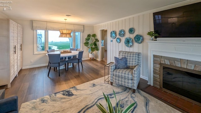 dining area featuring dark hardwood / wood-style flooring and ornamental molding