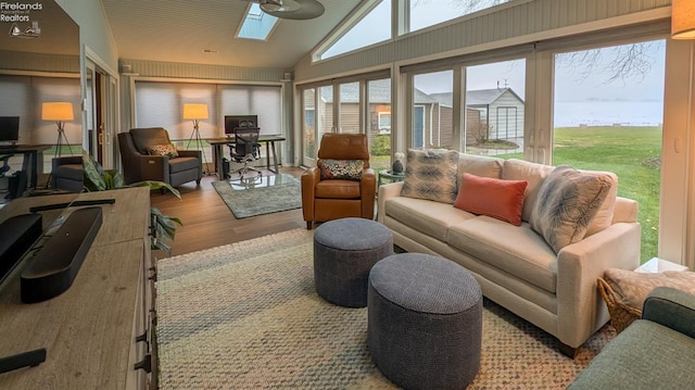 sunroom with lofted ceiling with skylight