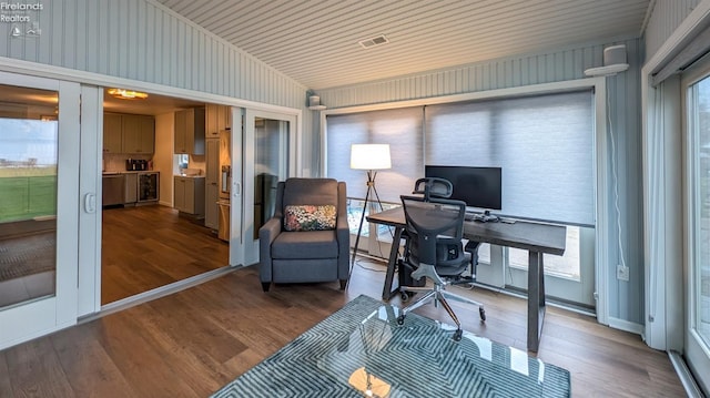 office space featuring wood-type flooring, a wealth of natural light, and lofted ceiling