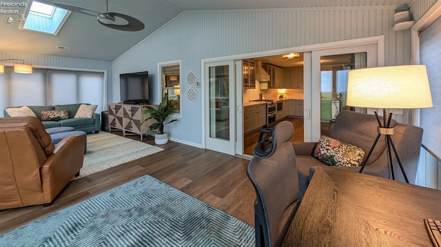 living room with dark hardwood / wood-style flooring, french doors, high vaulted ceiling, and a skylight