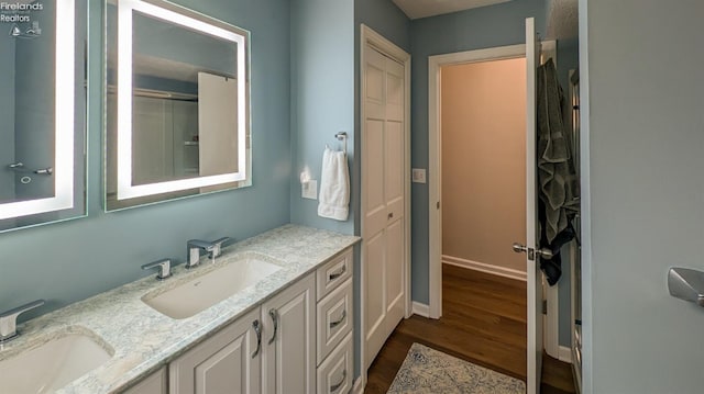 bathroom with hardwood / wood-style floors and vanity