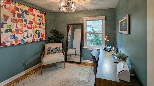 office area featuring light hardwood / wood-style floors and a notable chandelier