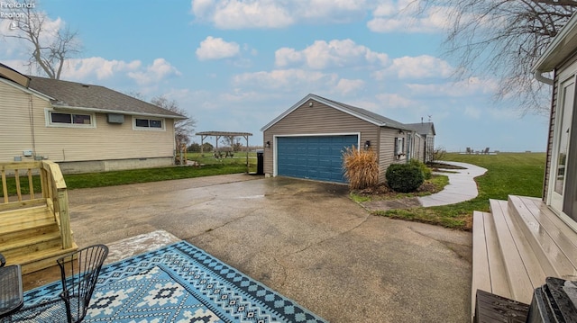 view of side of home featuring a lawn, a garage, and an outdoor structure