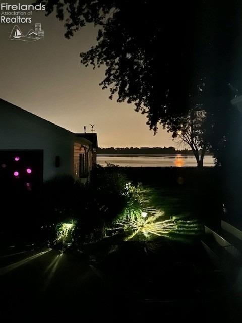 yard at dusk with a water view