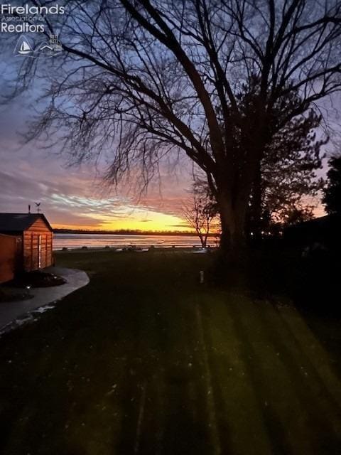 yard at dusk with a water view