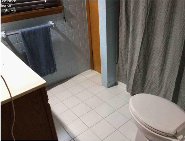 bathroom featuring tile patterned floors, vanity, and toilet