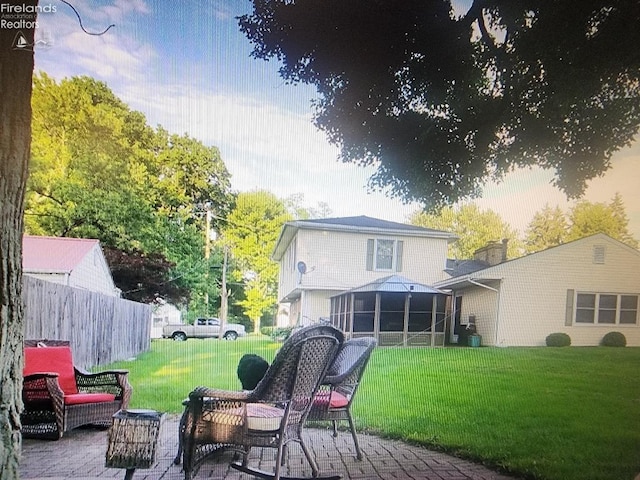 back house at dusk featuring a patio area and a yard