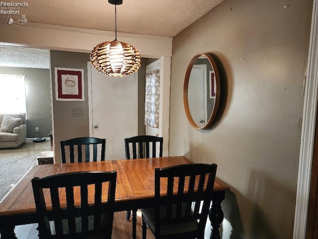 dining space with a textured ceiling and an inviting chandelier