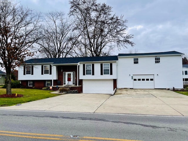 split foyer home with a front lawn and a garage