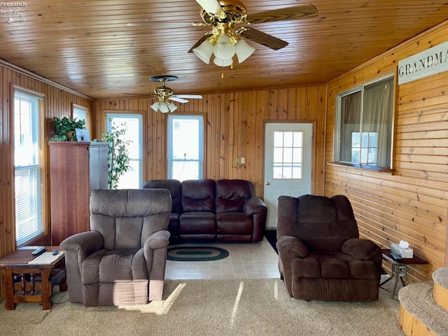 living room featuring ceiling fan, wood ceiling, and wooden walls