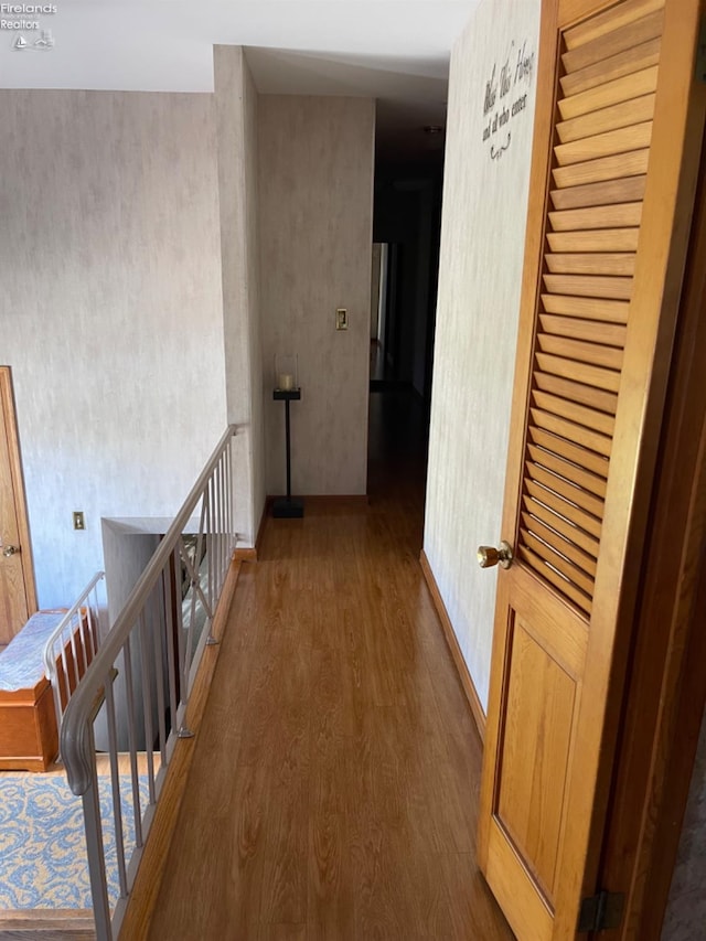 hallway with hardwood / wood-style flooring