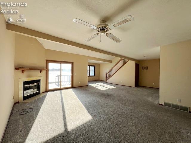 unfurnished living room featuring lofted ceiling with beams, dark carpet, and ceiling fan