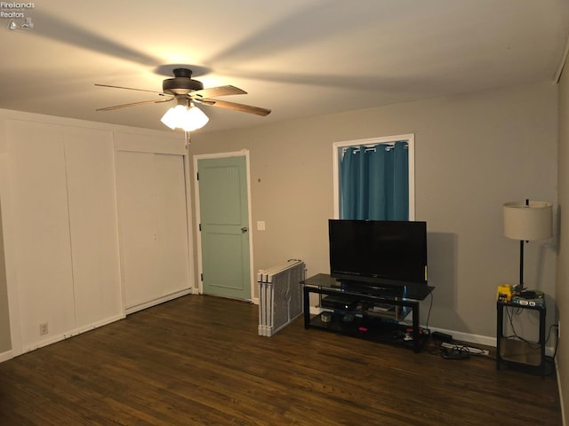 interior space with radiator, dark hardwood / wood-style floors, and ceiling fan