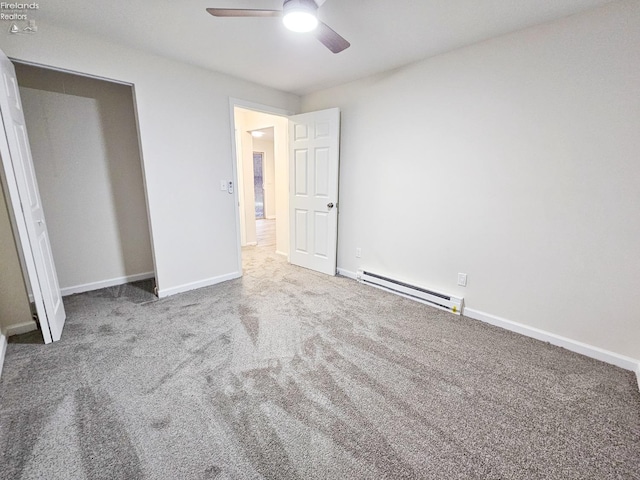 unfurnished bedroom with carpet flooring, ceiling fan, a closet, and a baseboard heating unit