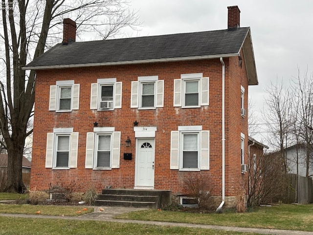 view of front of home featuring a front lawn and cooling unit