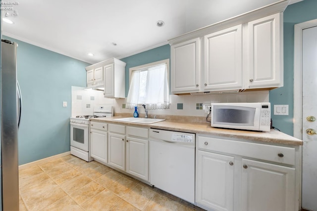 kitchen with decorative backsplash, white appliances, crown molding, sink, and white cabinets