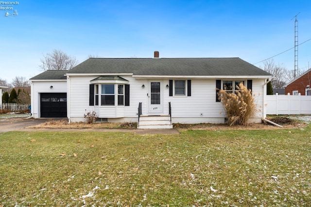 ranch-style house with a garage and a front lawn